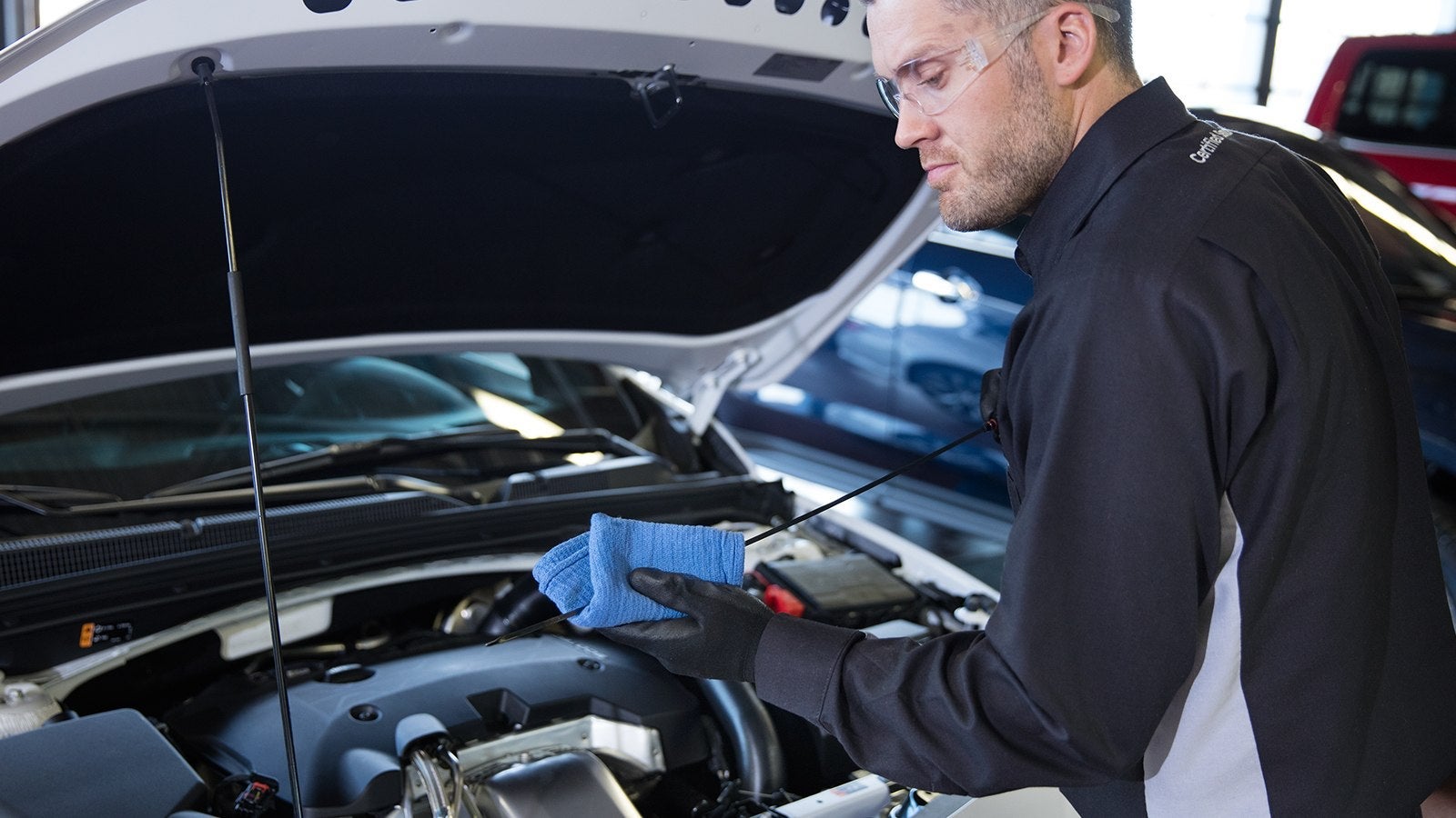 Mechanic working on car in shop