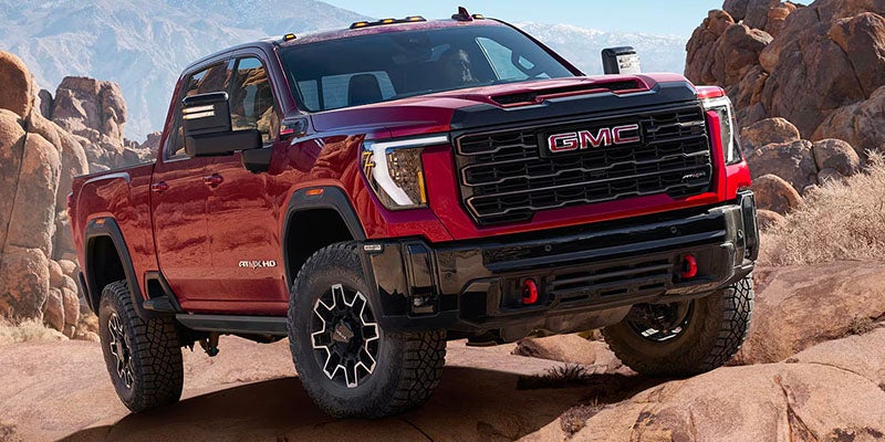 Red 2025 GMC Sierra 2500 HD in mountains