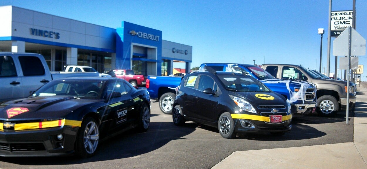 Cars dressed up in Batman decals outside of Vince's GM